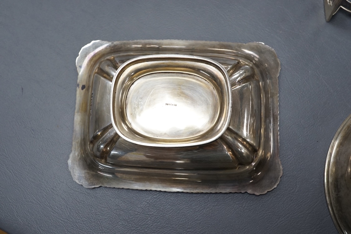 A pair of George V silver five bar toast racks, by Atkin Brothers, Sheffield, 1912, length 94mm, together with a silver muffin dish lid and a silver pedestal bonbon dish, 26.2ox